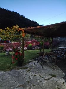 eine Terrasse mit einem Tisch und Stühlen im Hof in der Unterkunft XENONAS SOULIOU in Samonída