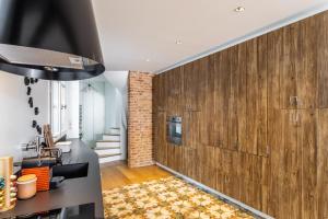 a living room with wood paneling and a brick wall at Maison Sévigné - Le calme du Thabor et la proximité du centre ville in Rennes