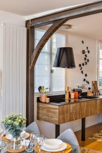 a kitchen with a dining table and a window at Maison Sévigné - Le calme du Thabor et la proximité du centre ville in Rennes