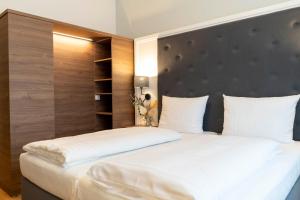 A bed or beds in a room at Signature Hotel Skarv