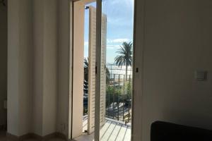 a door to a balcony with a view of the ocean at Apartamento Roses Playa in Roses