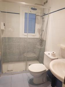 a bathroom with a shower and a toilet and a sink at Hostal Termes in Sitges