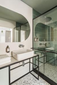 a bathroom with a sink and a shower at Angelus Apartments in Kraków