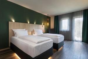 Ένα ή περισσότερα κρεβάτια σε δωμάτιο στο ACHAT Hotel Reilingen Walldorf