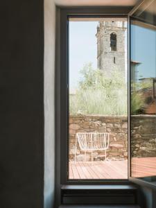 ein Fenster mit Blick auf einen Stuhl auf einer Terrasse in der Unterkunft Casa Olea Hotel in Cremia