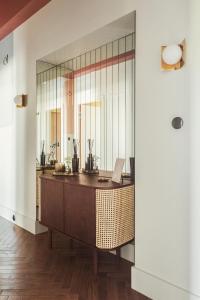 an office with a mirror and a desk at Angelus Apartments in Kraków