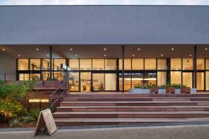 a building with a staircase in front of it at MUSTARD HOTEL SHIMOKITAZAWA in Tokyo