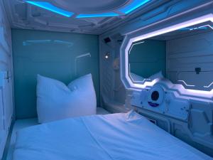 Space Night Capsule Hostel في برلين: غرفه فيها سرير وتلفزيون