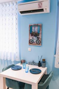 a table with blue walls and blue chairs with plates on it at The Place Apartments Hebrangova in Zagreb