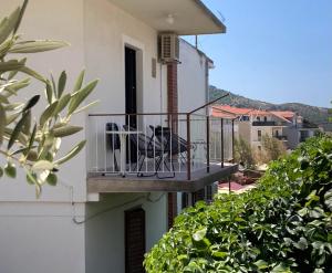 uma varanda com uma mesa e cadeiras num edifício em Rooms 22 - Beachfront em Primošten