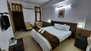 A bed or beds in a room at New Delhi YMCA Tourist Hostel