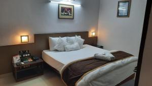 A bed or beds in a room at New Delhi YMCA Tourist Hostel