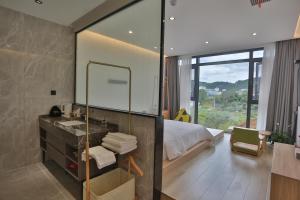 a bathroom with a bed and a sink and a mirror at Heaven's Gate Home Stay in Zhangjiajie