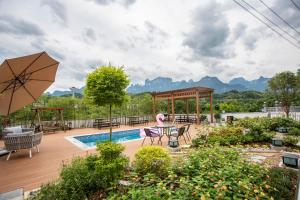 a backyard with a pool and a gazebo at Heaven's Gate Home Stay in Zhangjiajie