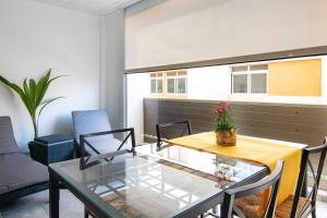 a dining room with a glass table and chairs at Loft Life 3 in Arrecife