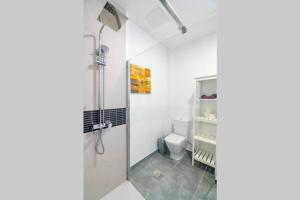 a white bathroom with a toilet and a shower at Loft Life 3 in Arrecife