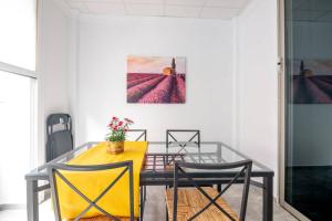 a dining room with a yellow table and chairs at Loft Life 3 in Arrecife