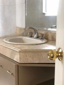 a bathroom counter with a sink and a mirror at B&B 518 in La Paz