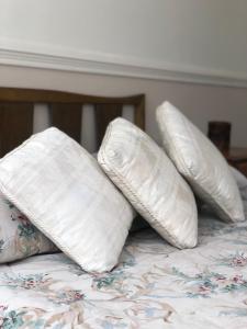 four white pillows sitting on a bed at B&B 518 in La Paz