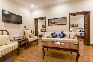 a living room with a couch and a table at Khattak Lodge Murree in Murree