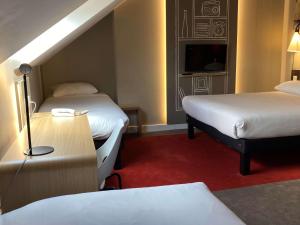 Ibis Wavre Brussels East में एक कमरे में एक या कई बेड