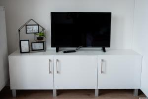 a white dresser with a flat screen tv on it at Wyszyńskiego 10 in Białystok