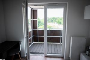 a sliding glass door with a view of a balcony at Wyszyńskiego 10 in Białystok