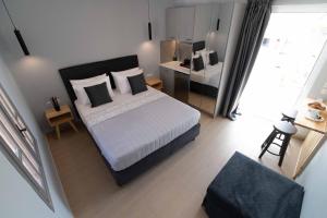 a bedroom with a king sized bed and a desk at Preveza Suitestay Apartments Dodonis 28 in Preveza