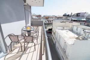 a balcony with chairs and a table on a ship at Preveza Suitestay Apartments Dodonis 28 in Preveza