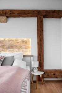 1 dormitorio con cama y pared de ladrillo en Florand Rooms&Wine, en Sopron