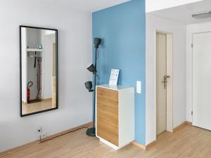 una stanza con specchio e cassettiera in legno di ARISER - Zug City View 1 Business Apartment a Zugo