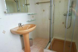 a bathroom with a sink and a glass shower at Chambre d hôtes de la Louve in Fréjus