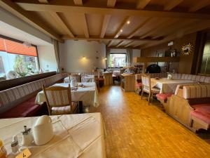 a restaurant with tables and chairs in a room at Hotel Garni Savoy in Castelrotto