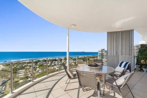 balcón con mesa, sillas y vistas al océano en Silver Sapphire on Sixth Penthouse, en Maroochydore