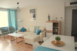 a living room with a couch and a table at Apartamento Dulcinea in Alcalá de Henares