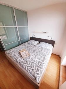 a bedroom with a large bed with a wooden floor at Apartment House Kamzik 26 in Donovaly