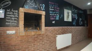 a brick fireplace with writing on the wall at Villa castelló salou in Salou