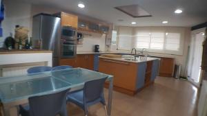 a kitchen with a table and chairs and a sink at Villa castelló salou in Salou