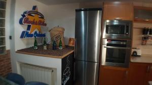 a kitchen with a stainless steel refrigerator and a microwave at Villa castelló salou in Salou