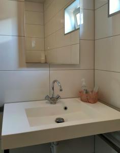 bagno con lavandino e specchio di b&b de Wensput a De Moer