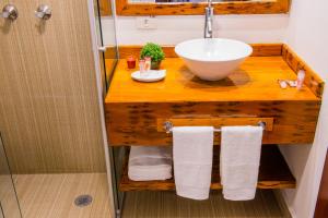 a bathroom with a sink and a counter with towels at Pousada das Lavandas in Campos do Jordão