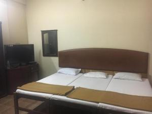 A bed or beds in a room at Anupam Residency