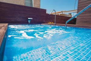 a swimming pool with blue water in a building at Holiday Rentals Tempa Museo in Seville