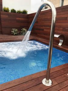 a water fountain in a swimming pool at Holiday Rentals Tempa Museo in Seville