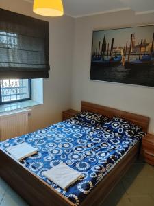 um quarto com uma cama com um edredão azul em Noclegi przy Browarnej em Żyrardów