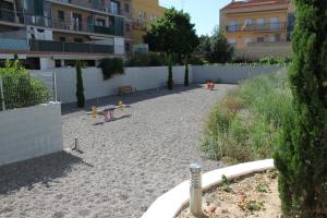 a playground with toys in the sand in a city at Apartaments Centre Figueres in Figueres