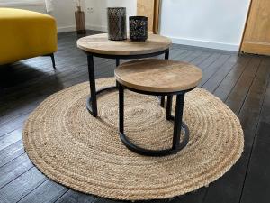 two tables sitting on top of a rug at Au bord de l'Ourthe in La Roche-en-Ardenne