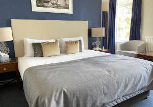 a bedroom with a large bed with pillows at Haven Hotel in Poole