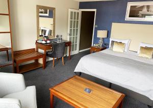 a hotel room with a bed and a desk at Haven Hotel in Poole