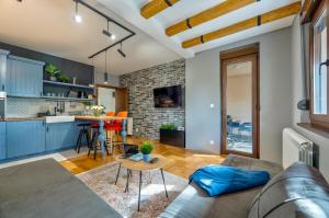 a living room with a couch and a table at Apartment ERAK HILL in Zlatibor